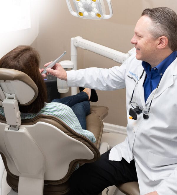 Dentist performing laser deep teeth cleaning in Oakland, NJ